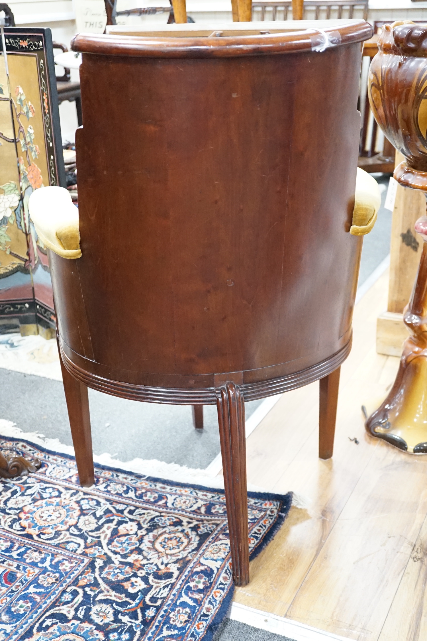 A stylish Art Deco mahogany elbow chair by Trollope and Son, numbered 4088, height 95cm *Please note the sale commences at 9am.